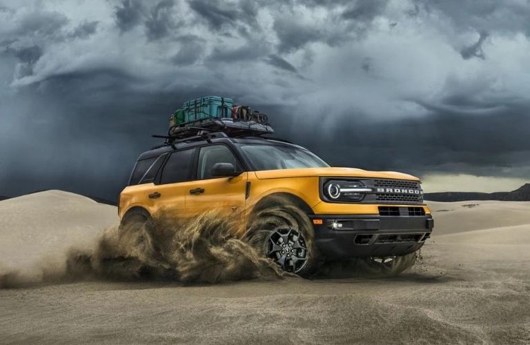 A yellow 2022 Ford Bronco Sport driving in the desert