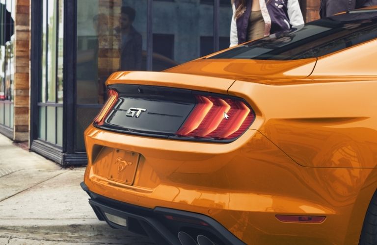 Rear panel of an orange 2022 Ford Mustang