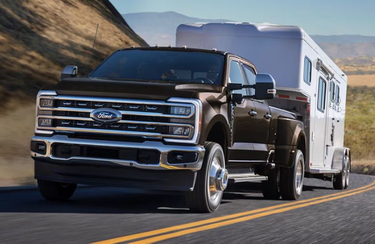2025 Ford F-350 front view towing on a road