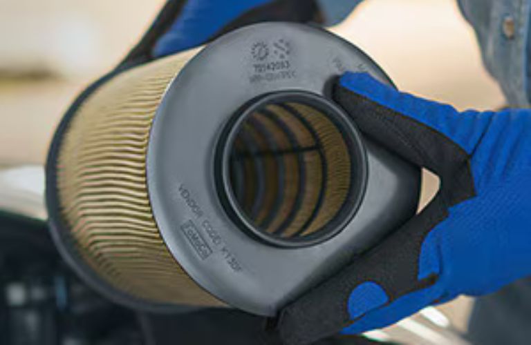 a Ford air filter in the hands of a technician
