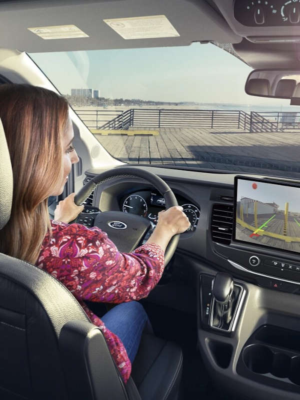 A woman using the navigation system in the Ford Transit