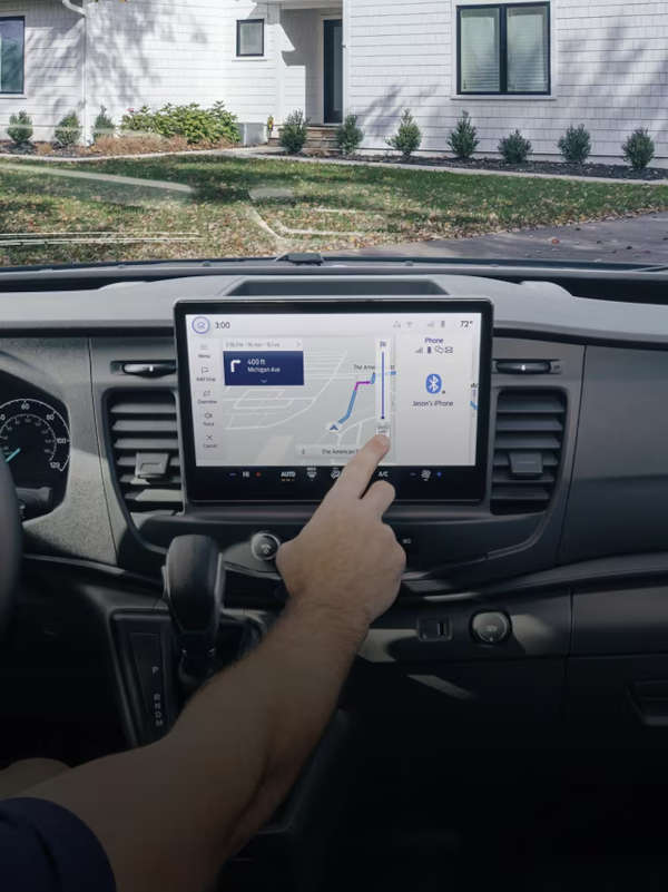 A man using the high-tech infotainment system in the 2025 Ford Transit